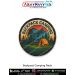 High detail Backpack Camping Patch displaying an outdoor campsite illustration with a trekking backpack, orange tent, mountain silhouettes, sunset tones and merrow stitched border crafted for jackets, travel rucksacks, camping gear and adventure collector