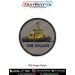 A round INS Anjan patch featuring a high detail digital illustration of the INS Anjan vessel with a bright yellow cabin structure black hull grey sea shading a grey fabric background and a bold navy blue text INS ANJAN below surrounded by a strong black m