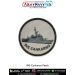 A round INS Cankarso patch featuring a detailed grey patrol vessel with radar mast deck rails hull contours and superstructure detailing printed on a textured light grey fabric background with bold navy text INS CANKARSO below and a strong black merrow st
