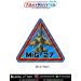 MiG-27 Flogger Fighter-Bomber Aircraft Patch featuring a top-down green and tan camouflage swing-wing jet with Indian Air Force-style roundels, blue triangular background, red and yellow borders and bold MiG 27 lettering